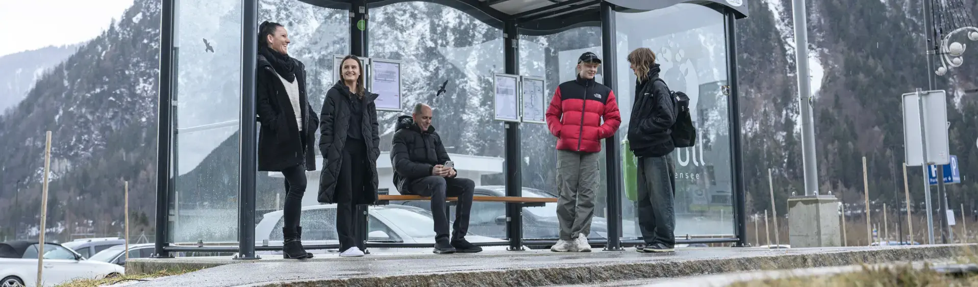 A group of people waiting for the bus in the Achensee atoll in winter.