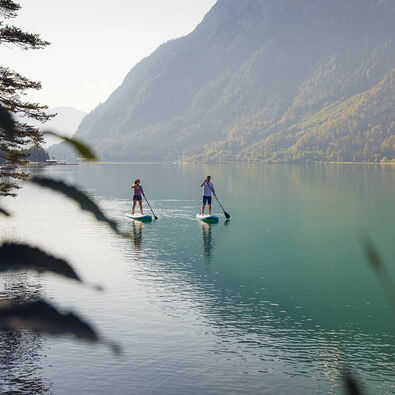 Explore Lake Achensee at a leisurely pace as you stand on a large surfboard and use a paddle to propel yourself through the water.