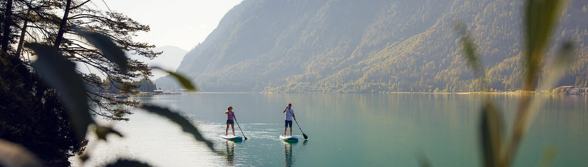 Explore Lake Achensee at a leisurely pace as you stand on a large surfboard and use a paddle to propel yourself through the water.