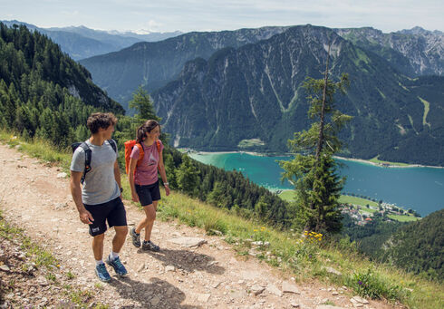 Hiking programme in summer A couple walks along a hiking trail in the Rofan Mountains enjoying the beautiful wildflower meadows.