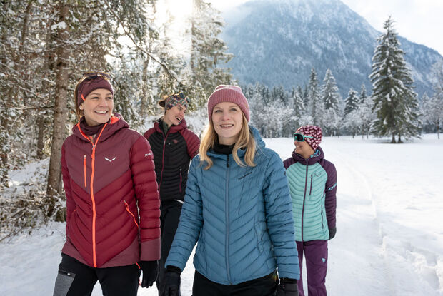 A group of friends go on a winter hike in the Gerntal valley in the Karwendel Nature Park in glorious weather.