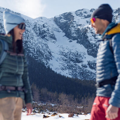 Enjoying a winter hike through the snowy landscapes in the Mountaineering Village Steinberg am Rofan on a sunny day.