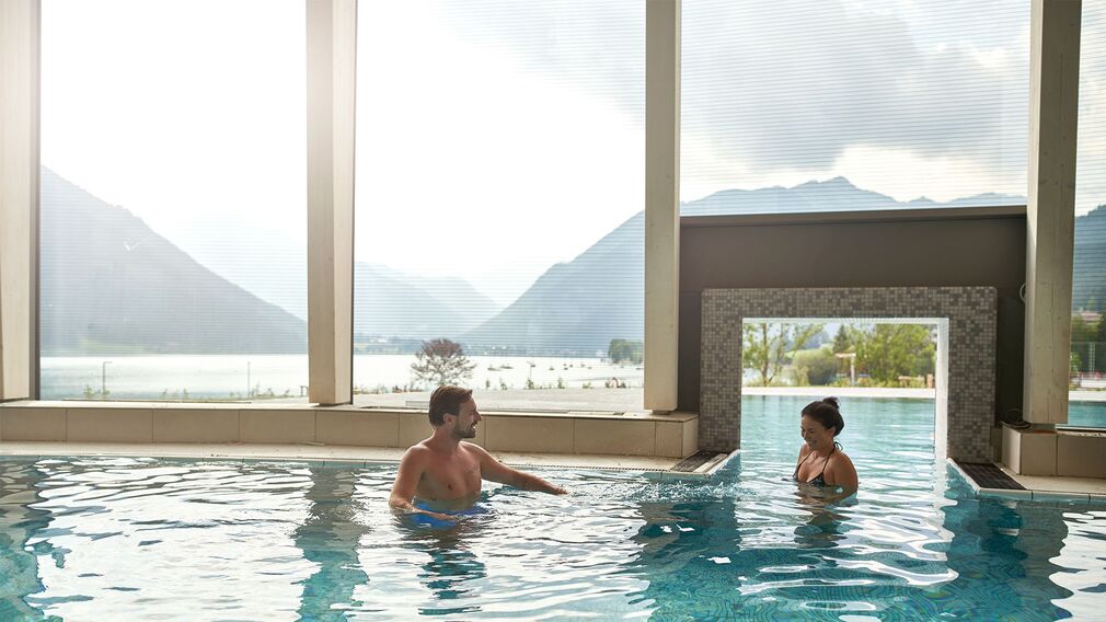 on a bubble lounger in the outdoor pool of the Panorama-BAD