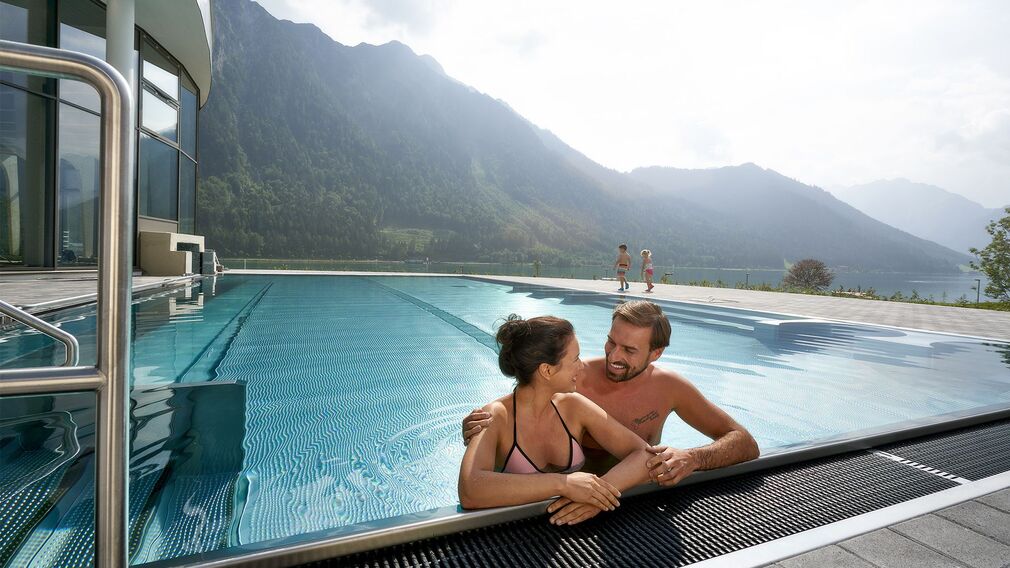 on a bubble lounger in the outdoor pool of the Panorama-BAD