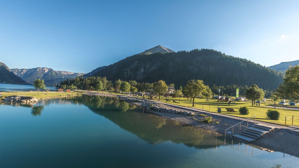 Children clearly enjoy themselves at the playground by the lake in Achenkirch.