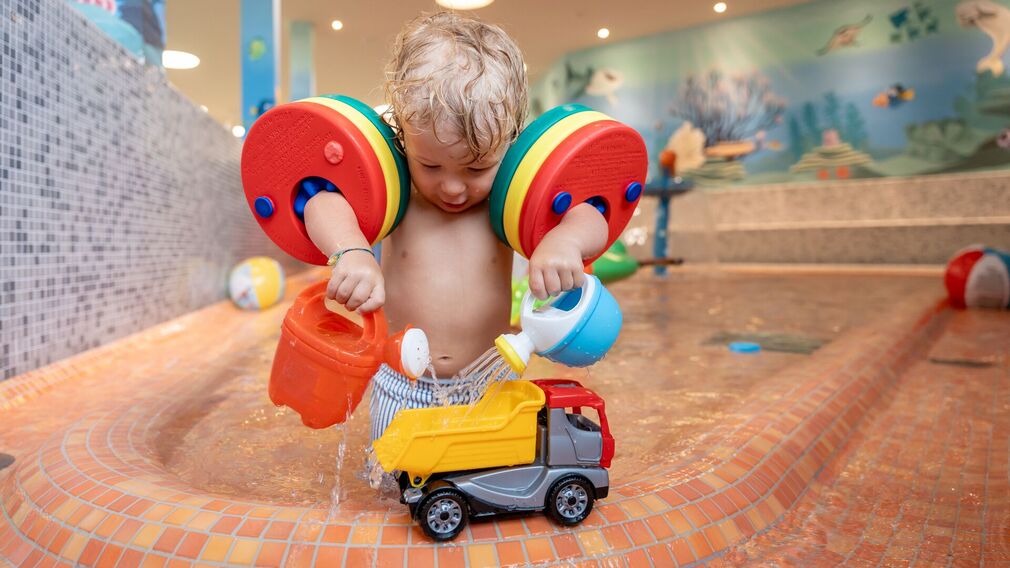 on a bubble lounger in the outdoor pool of the Panorama-BAD