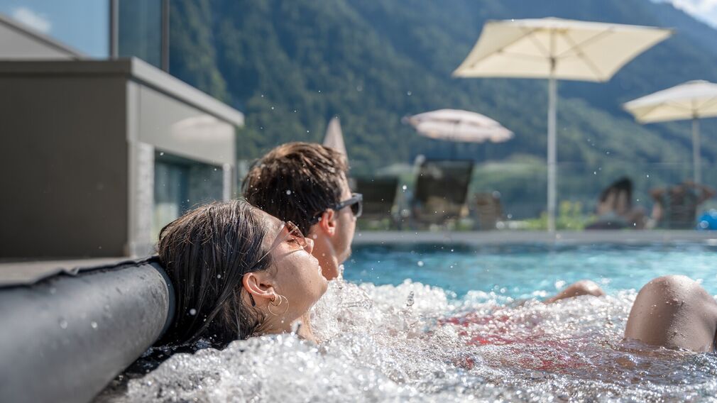 on a bubble lounger in the outdoor pool of the Panorama-BAD