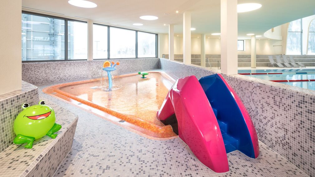 on a bubble lounger in the outdoor pool of the Panorama-BAD